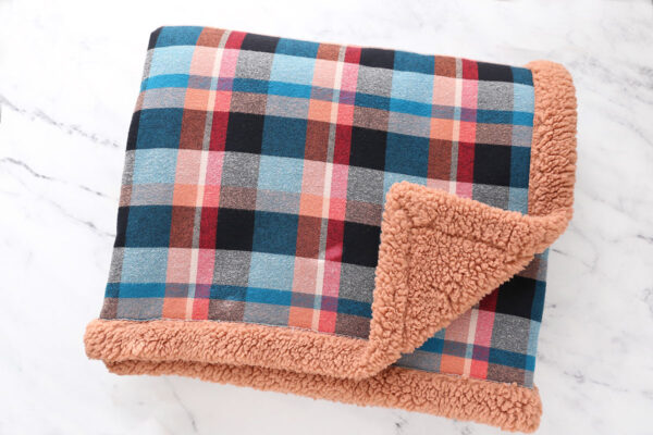 Flannel blanket lined with sherpa.