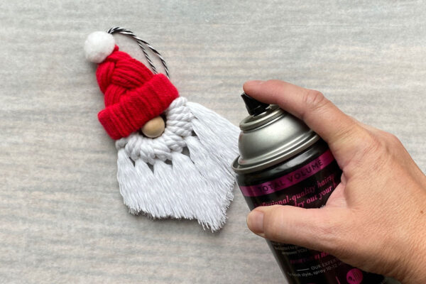 Spray hair spray on the beard to stiffen it.