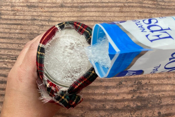 Filling the jar with epsom salt.