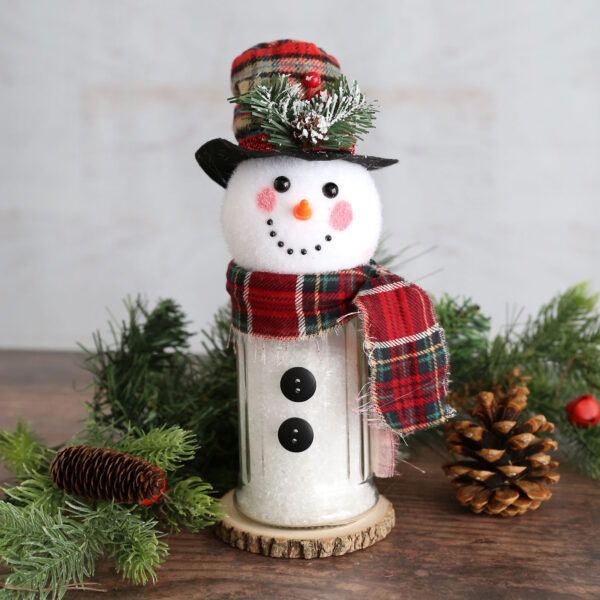 Snowmen made from sugar jars and snowman head ornaments.
