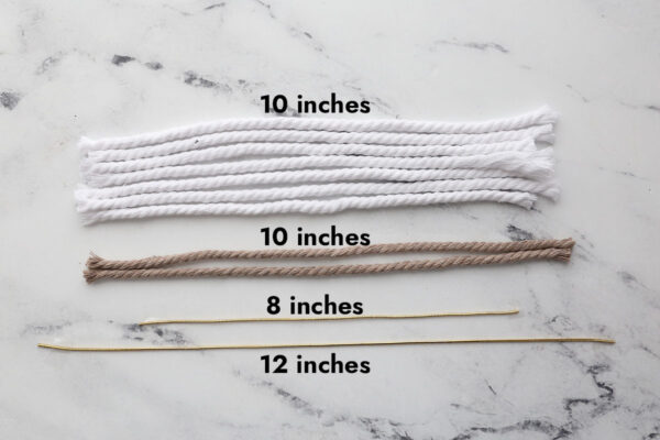 7 pieces of 10-inch white cord, 2 pieces of 10-inch brown cord, 1 piece of 12-inch gold elastic cord and 1 piece of 8-inch gold elastic cord.