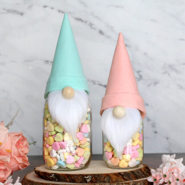 Mason jars decorated to look like gnomes.