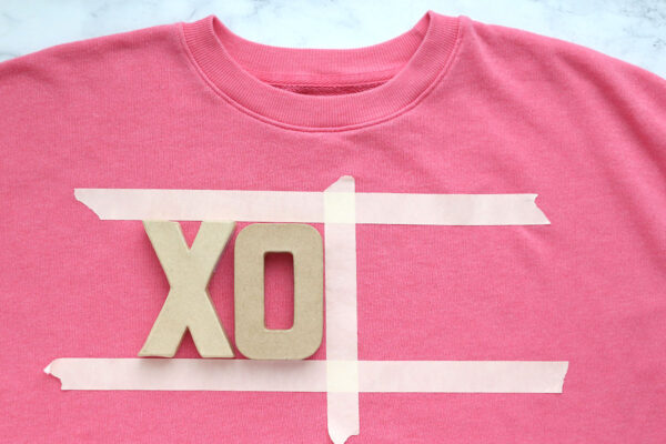 Masking tape on sweatshirt to help position the letters.