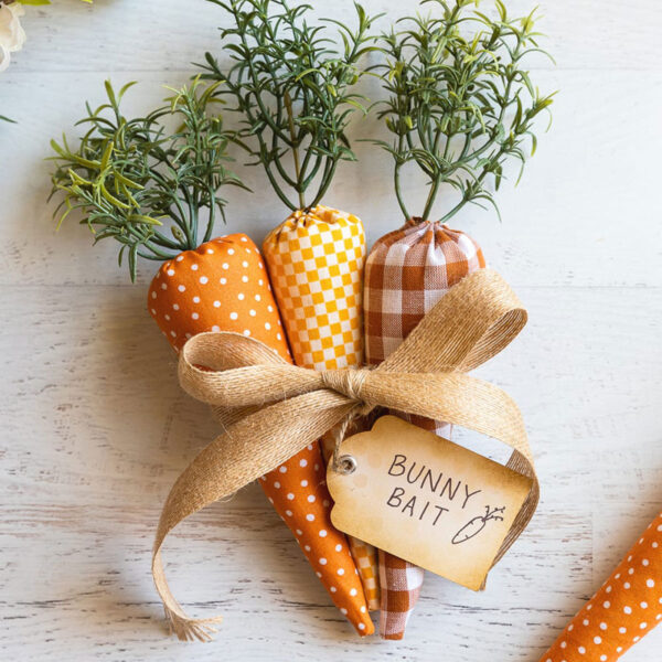 Carrots made from fabric and stuffing.