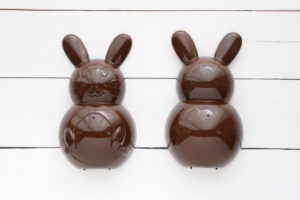 Front and back of plastic bunny spray painted brown.