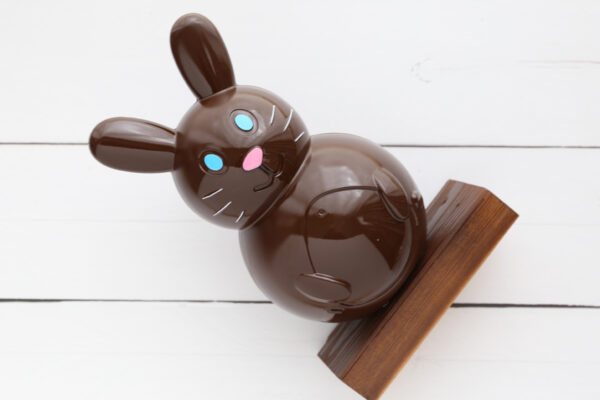 Faux chocolate bunny glued to wood base.