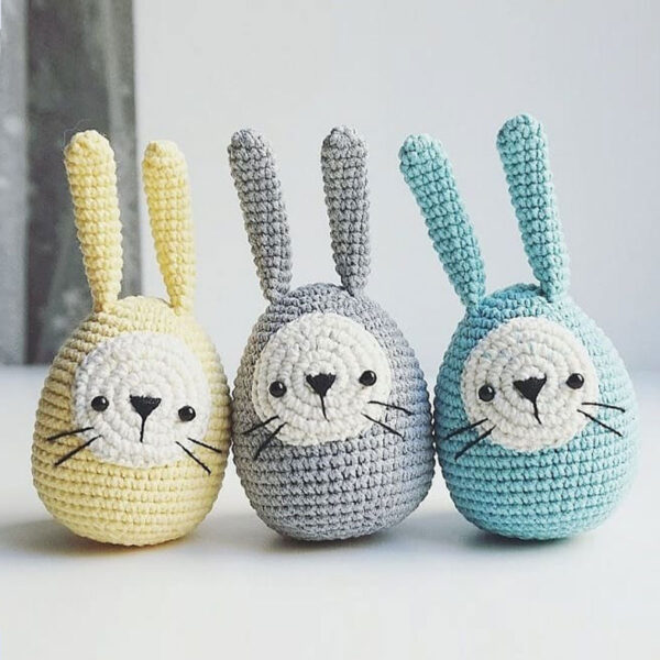 Crocheted bunnies in the shape of Easter eggs.