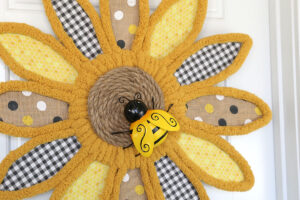 Sunflower wreath with bee decoration.