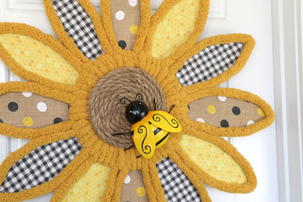 Sunflower wreath with bee decoration.