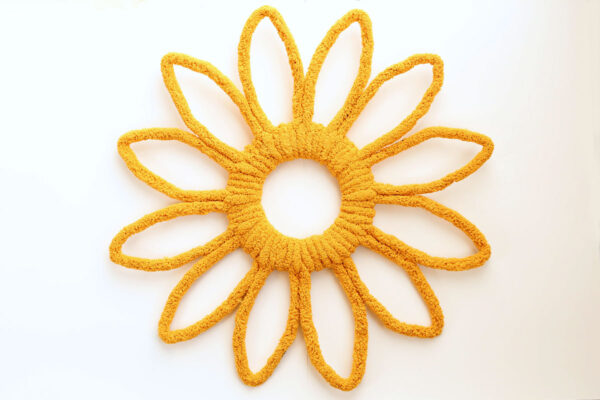 Wreath completely wrapped with yarn.