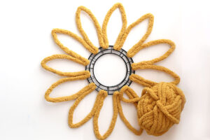 Wreath with yarn glued to outline all the petals.