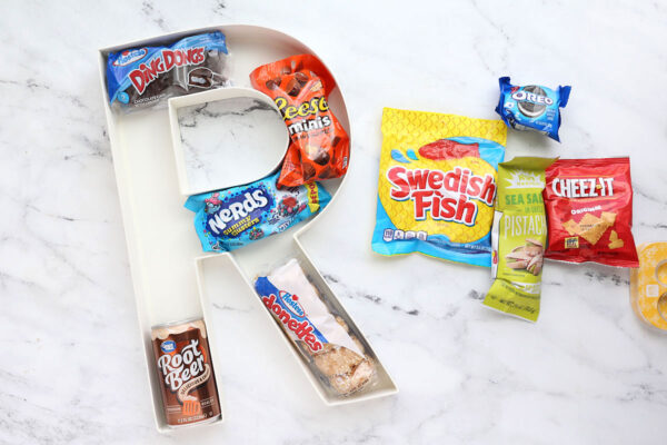 Fitting treats into the cardboard letter.