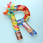 Cardboard letter initial filled with treats.