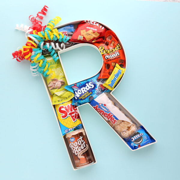 Cardboard letter initial filled with treats.