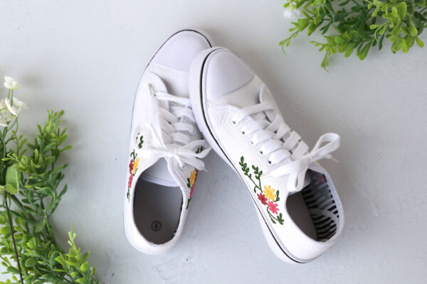 Shoes with flower embroided on the side.