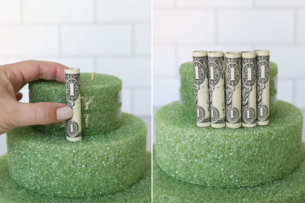 Placing rolled dollar bills against the tape.