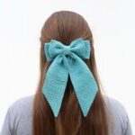Girl with how in her hair.
