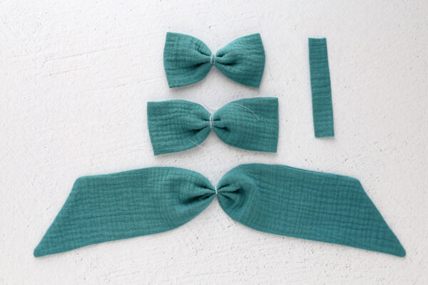 Both bow pieces and tail piece tied in the middle with thread.