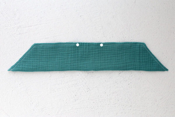 Tail piece folded in half lengthwise and sewn, with opening left between dot marking on pattern.