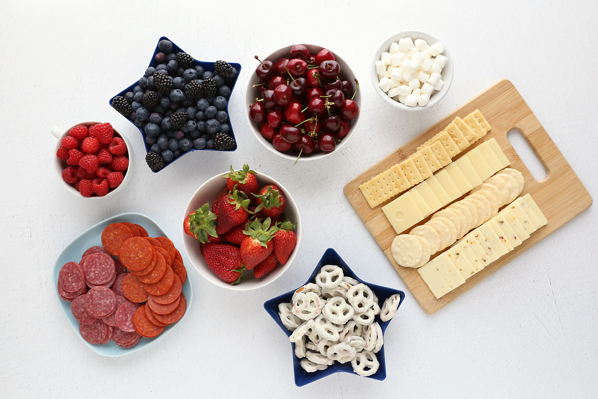 Berries, cheeese, crackers, pepperoni and salami, white chocolate pretzels, mini marshmallows.
