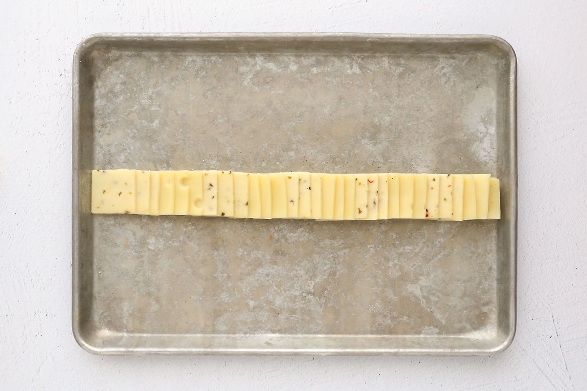 Cookie sheet with row of cheese across it.