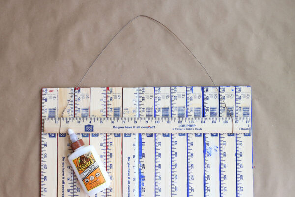 Half yardstick glued across the back of the other yardsticks.