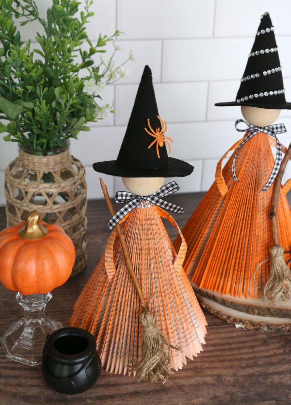 Witches made from folded paperback books.