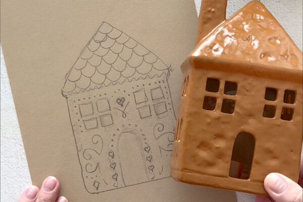 Traced house on paper with designs.