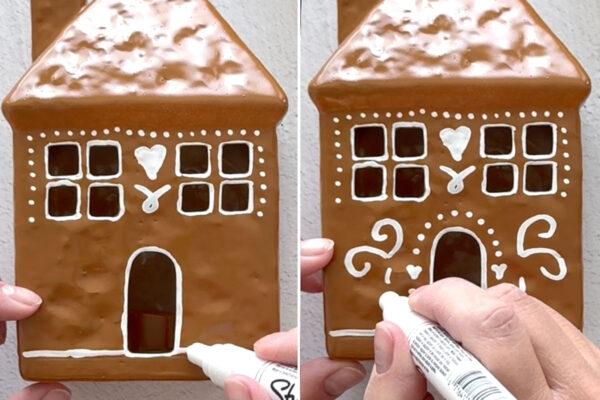 Using paint pen to add designs to the house.