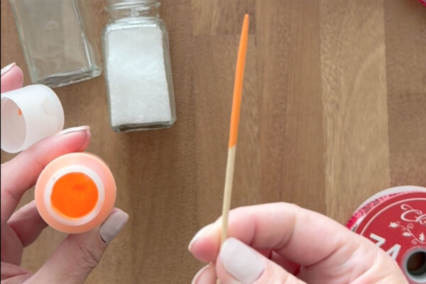 Toothpick dipped into orange paint.
