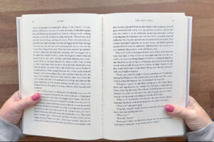 Opening up book and creasing binding.
