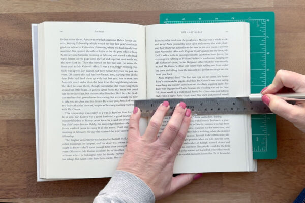 Measuring halfway up the book and cutting with exacto knife.
