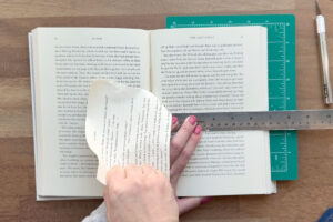Ripping off top half of book pages.