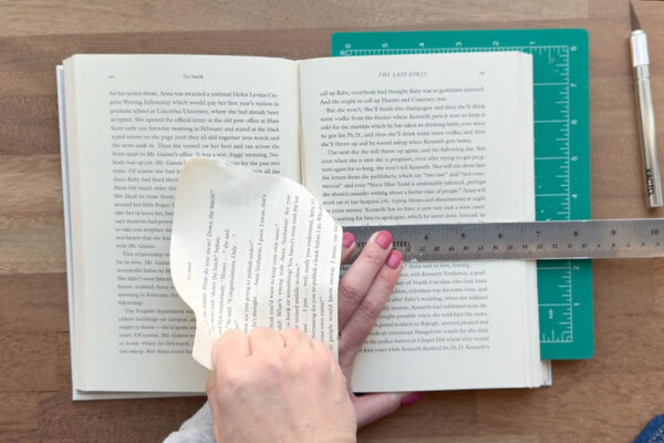 Ripping off top half of book pages.