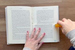 Adding adhesive in corners of pages.