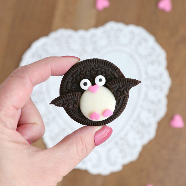 Hand holding Oreo penguin treat.