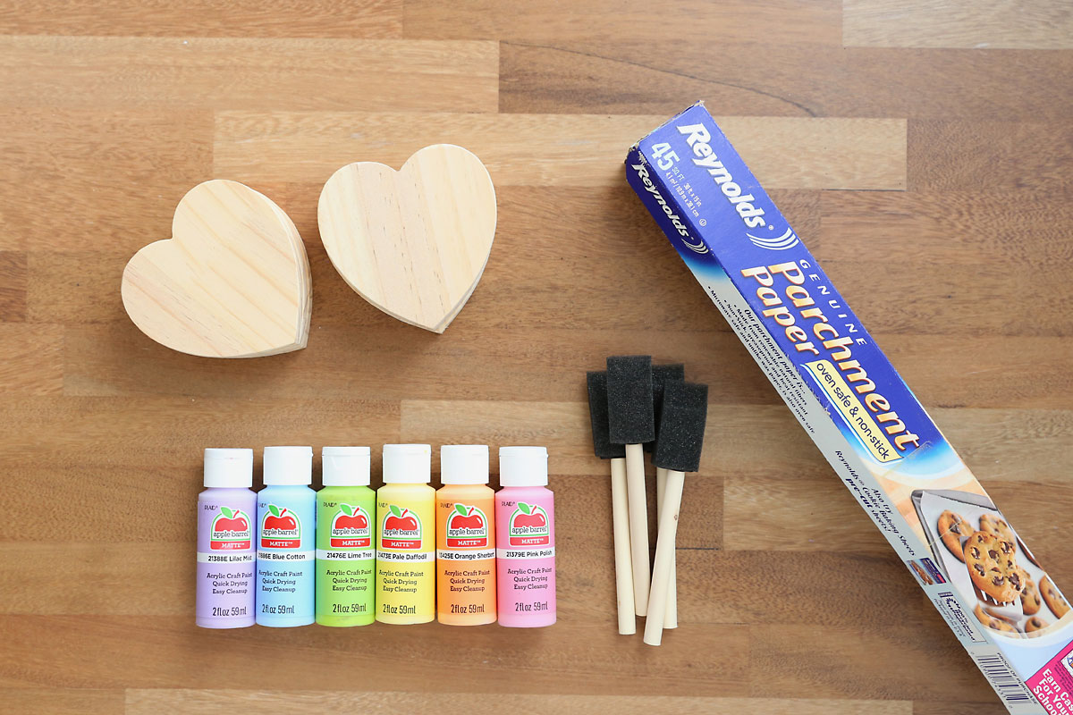 Wood heart cutouts, acrylic paint, foam paintbrushes, freezer paper.