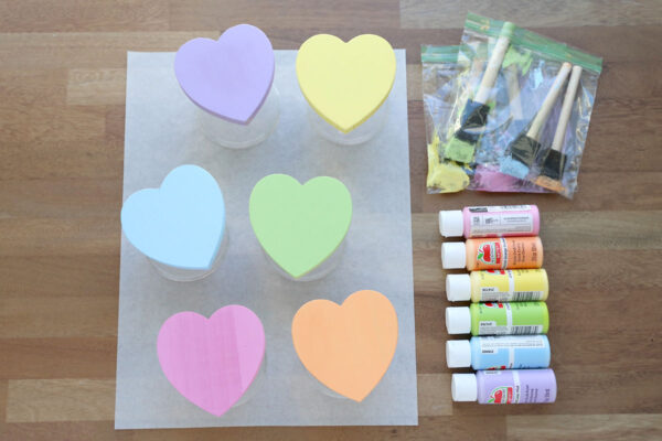 Hearts painted pastel colors; paintbrushes in ziplock bags.