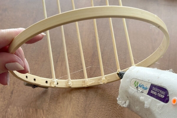 Adding more hot glue over the skewers to secure.