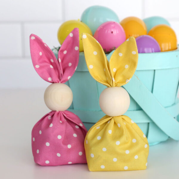 Two fabric bunny bags filled with treats.