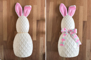 Putting small egg on middle one, bow tied around them.