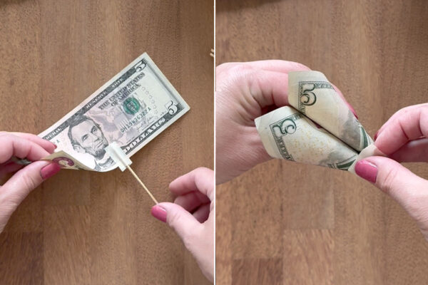 Pulling in the bottom corners of the bill to create a petal shape, taping to secure.