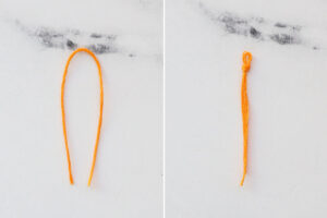 Fold embroidery floss in half, tie knot near the folded end.
