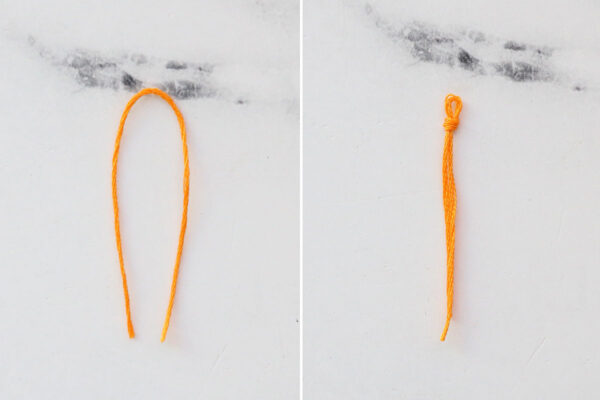 Fold embroidery floss in half, tie knot near the folded end.