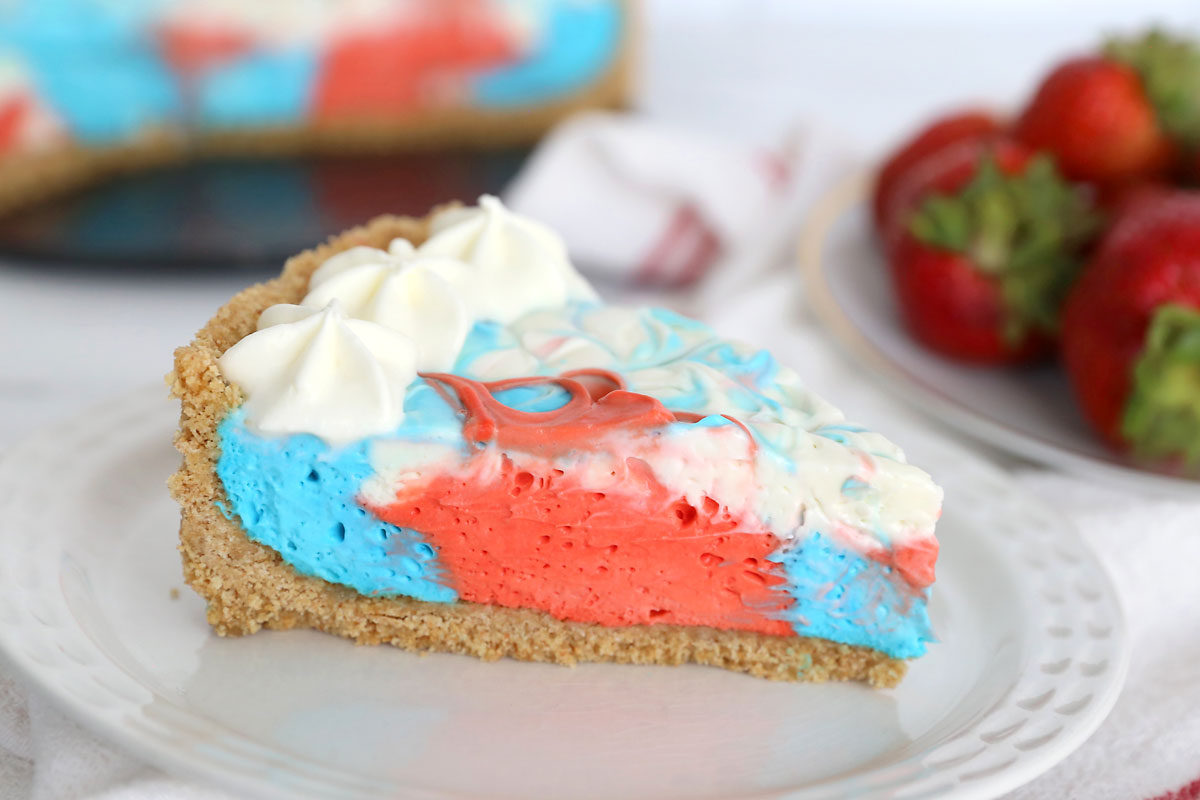 Slice of red, white and blue no bake cheesecake.