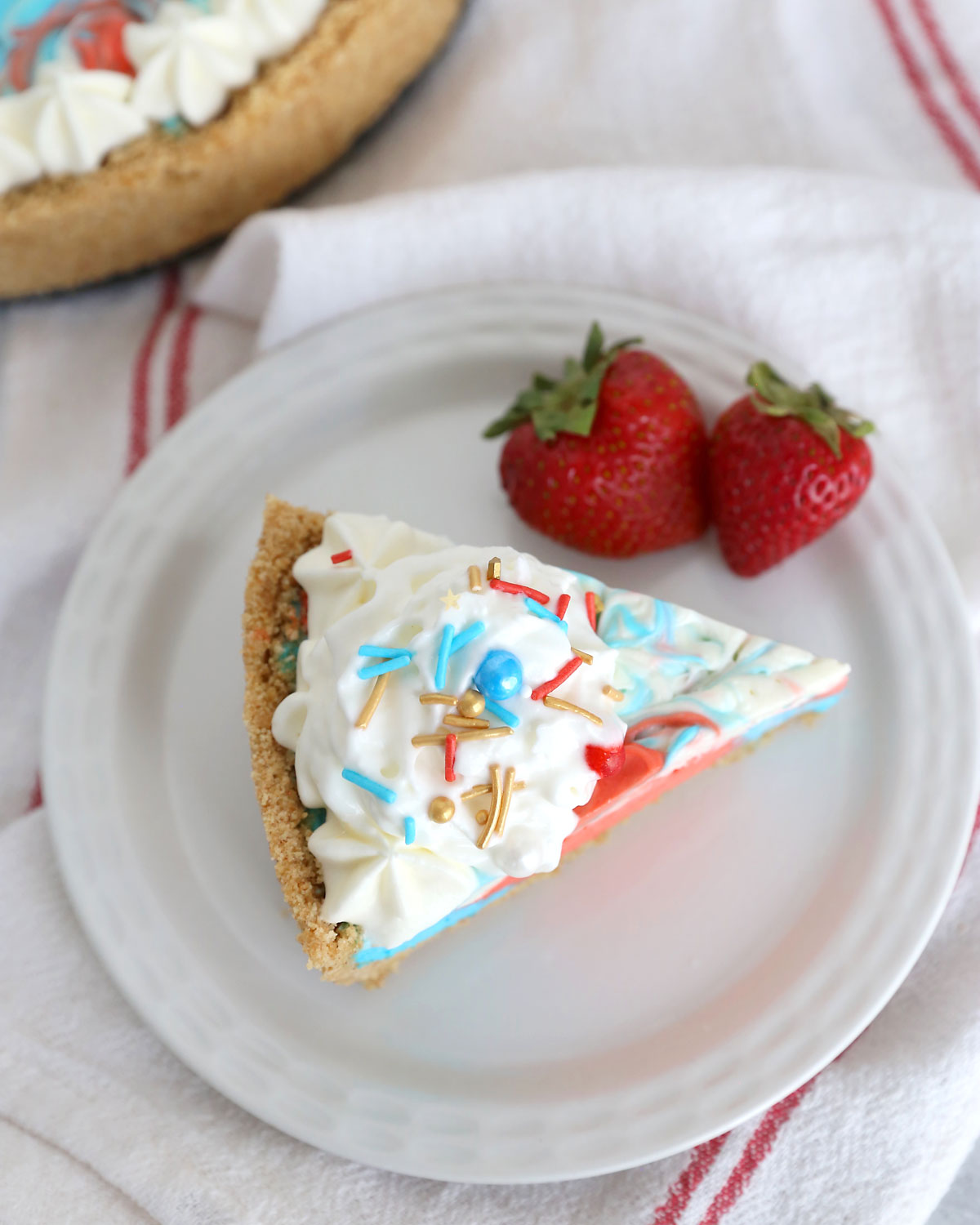 Slice of red, white and blue no bake cheesecake.