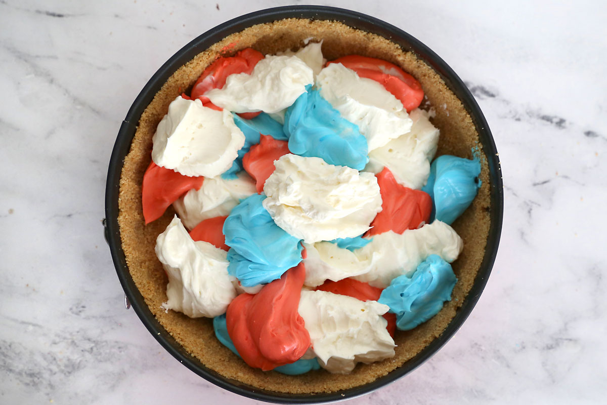 Cheesecake mix dolloped inside crust.
