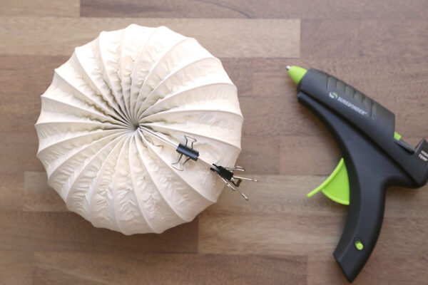 Coiling dryer vent hose around to create a pumpkin shape; hot glued.
