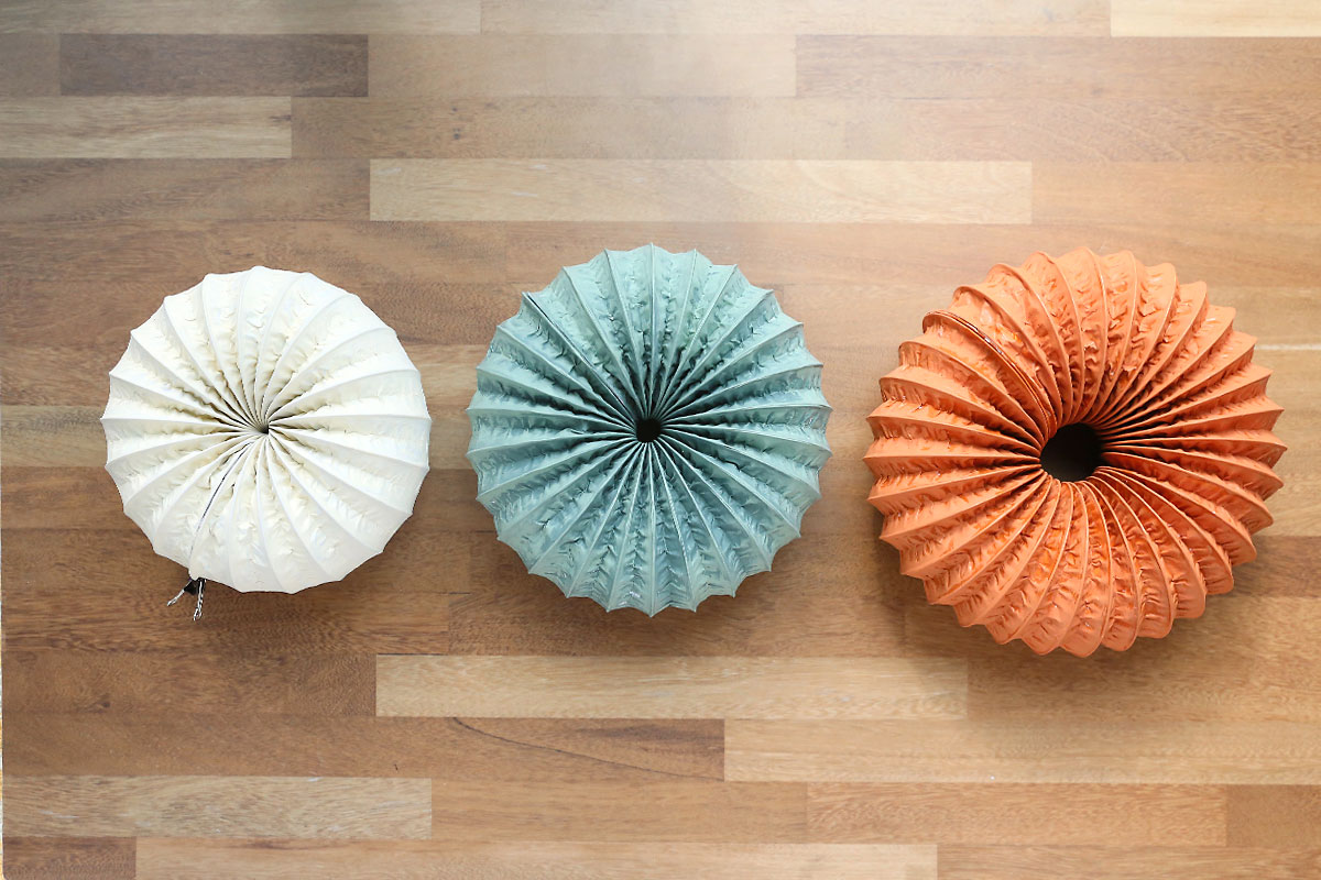 Three different size "pumpkins" made from dryer vent hose.