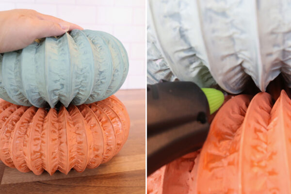 Placing middle pumpkin on large pumpkin, adding hot glue where they touch to adhere.